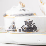 Herend Apponyi ANG Black-Gold tea set for two. Closeup on the fine china teacup painted with Chinese Bouquet design.