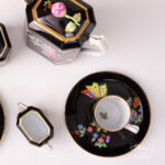 Herend Victoria Black coffee set octagonal VE-FN. Black background with Victoria butterflies and peonies.