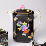 Herend Victoria Black coffee set octagonal VE-FN. Black background with Victoria butterflies and peonies.