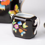 Herend Victoria Black coffee set octagonal VE-FN. Black background with Victoria butterflies and peonies.